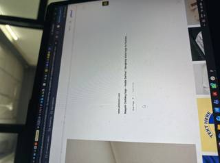 A laptop screen displaying two beige tags with strings, showing text and patterns, with browser tabs visible on top.