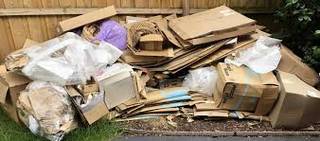 Pile of cardboard boxes and packaging for removal in W4