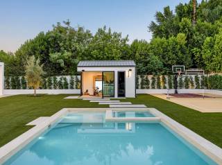 Photo showing a modern outdoor pool, garden, and small building in CHESHIRE, CH1